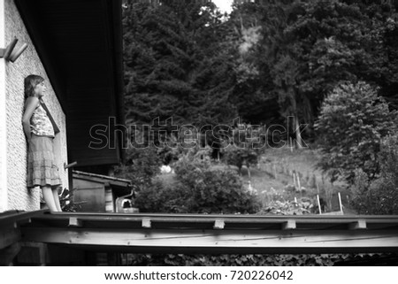 Blonde litle girl on balcony black and white photo 