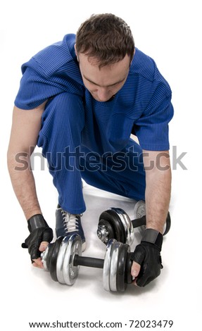 Healthy muscular bodybuilder exercising with dumbbels.White isolated.