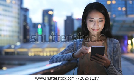 Asian Woman using smart phone at night 
