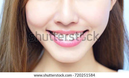 beauty woman smile happily with health teeth on blue background
