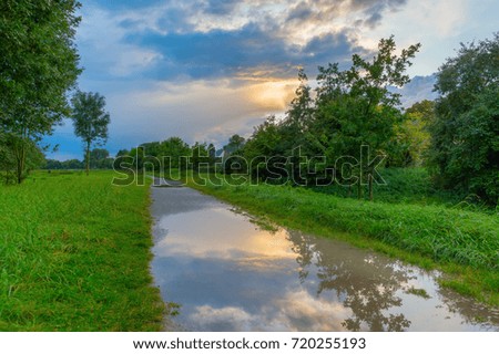 picture of a rural landscape at dusk with cloudy sky