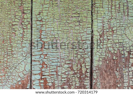 Old wooden fence whith cracked paint in the village. Background vintage texture
