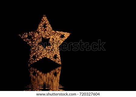 beautiful shiny gold Christmas star on a black background Blur
