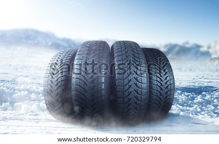 Winter tire on ice Royalty-Free Stock Photo #720329794