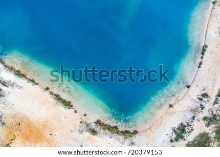 Aerial photograph with drone, corner of a gravel pond with sandy beach