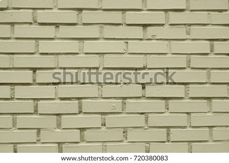 Pastel green colored brick wall.