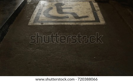 Disabled parking space and wheelchair way sign and symbols on street