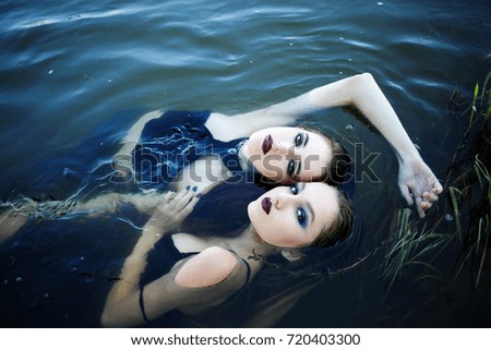 Two beautiful girls in the water. Fashion photography