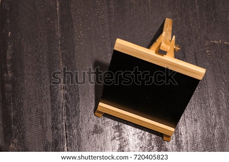 Mini blackboard or menu board on the wooden table. Shot from aerial view.