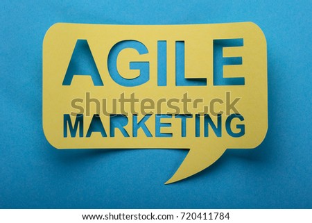 Agile Marketing Words Cut Out On Speech Bubble Over Blue Background