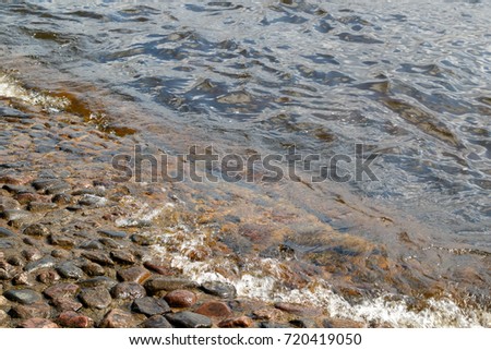 The water of the river Neva washes the stones of the base of Peter-Paul Fortress Fortress in Saint Petersburg, Russia.