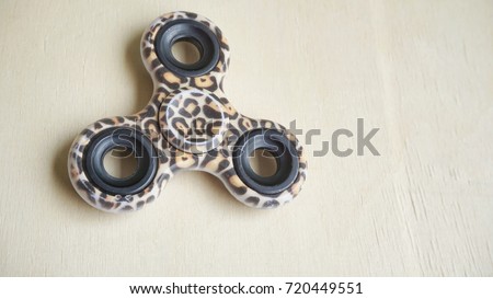 A  fidget spinner device isolate on white background. Selective focus.