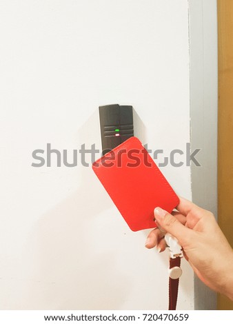 Card access control system. A hand is holding an access card and scan to the machine. Business and office concept.