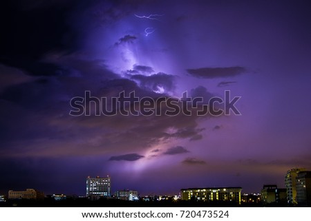 Lightning storm over black sky at Bangkok. Lightning with dramatic clouds. It's night thunder-storm. Clouds, thunder lightnings and storm is heavy before rain fall. Lightening striking on the city.