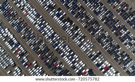 Aerial top down view photo vehicle lot showing new produced cars by automakers stored there for further distribution towards car dealers port area where ships bring vehicles in mass production scene Royalty-Free Stock Photo #720575782