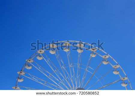 Ferris wheel over the blue sky background
