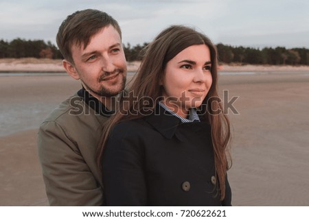 young loving couple on the beach in autumn close-up.