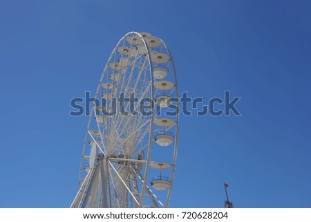 Ferris wheel over the blue sky background