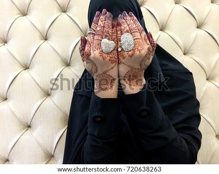 Young muslim islamic girl wearing hijab and pray