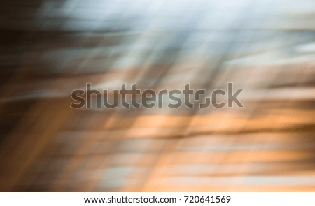 Brown, grey, orange abstract colorful texture with straight lines. Artificial material with scratches. Rays of light. Background, wallpaper, backdrop.