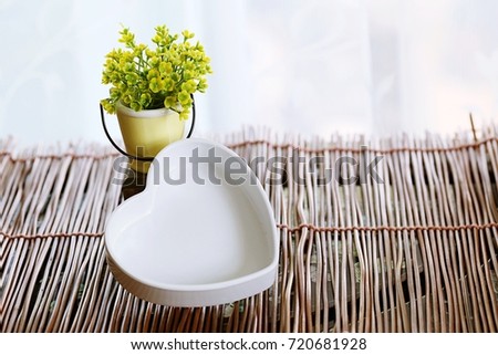 Heart shape and flower pot decoration closeup interior window blur background