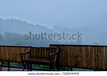 vintage balcony photo in the rain season with mountain shadow in the mist beautiful like drawing picture