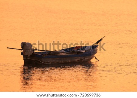 Reflection of Single Boat with Burning Sky During Sunrise