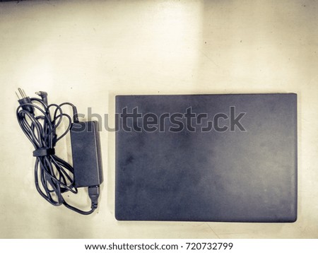 computer laptop and adapter close and put on white table