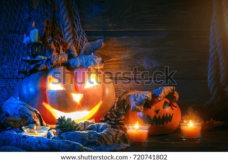 Halloween pumpkins on a wooden table at night.