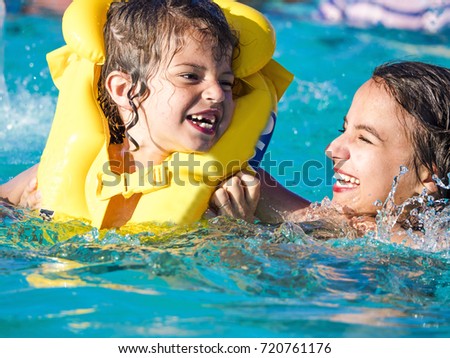 Children rest in the pool in summer