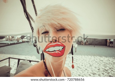 Young blond women posing with fake lips