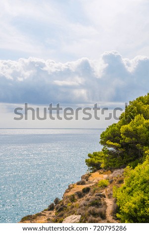 high cliff above the sea, summer sea background, many splashing waves and stone, sunny day