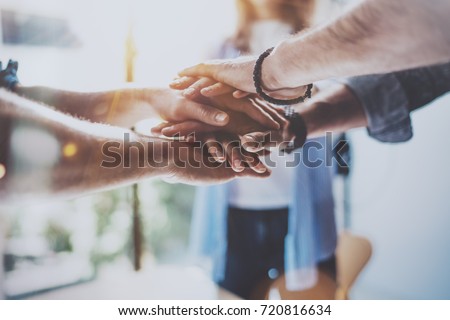 Teamwork business concept.Close up view of group of three coworkers join hand together during their meeting. Horizontal.Blurred background Royalty-Free Stock Photo #720816634