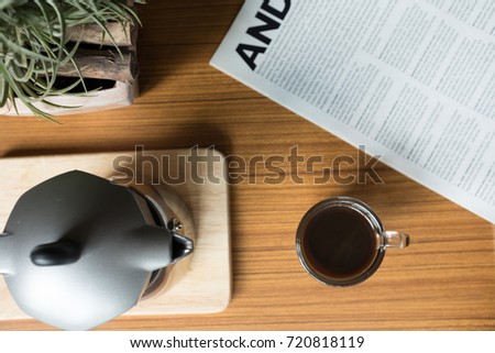 Hot Coffee in Espresso Cup with Magazine on the Table Royalty-Free Stock Photo #720818119