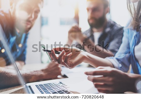 Business people brainstorming concept.Coworkers working at office.Closeup view of female hand pointing on laptop screen. Horizontal, flares effect