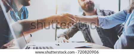 Business partnership handshake concept.Photo two coworkers handshaking process.Successful deal after great meeting.Horizontal, blurred background.Wide Royalty-Free Stock Photo #720820906