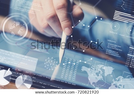 Concept of digital diagram,graph interfaces,virtual display,connections icon.Man using contemporary electronic tablet at office.Blurred background. Horizontal Royalty-Free Stock Photo #720821920