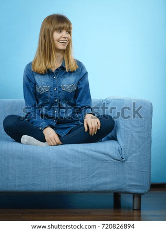 Happiness face expressions concept. Portrait of happy cheerful blonde woman smiling with joy wearing blue jeans shirt.