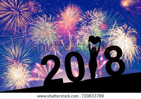Colorful Fireworks  on blue and purple twilight background to celebrate 2018 new year eve occasion or events with woman silhouette, holiday celebration concept