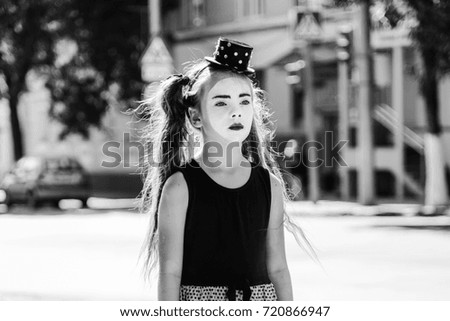 sad little girl mime standing on the road in the city