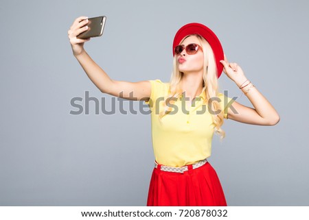 Trendy beautiful hipster girl taking selfie with mobile phone