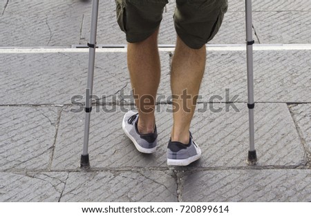 Young man walking with crouches