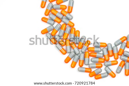 Gray-orange capsule pills on white background. Cephalosporins drug. Antibiotic capsule pills. Pharmacy drugstore. Pharmaceutical industry. Pharmaceutics concept. Antibiotic drug resistance concept.