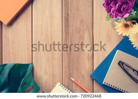 top view book and pencil note on wood table with Desk and learning