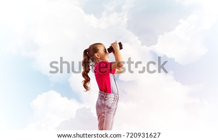 Little cute girl in overalls against sky background dreaming about future