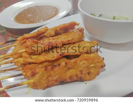 Soft focused picture of Pork Satay with peanut source