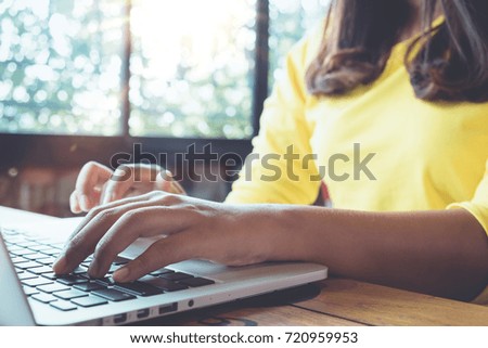 woman casual style using mobile laptop. young businesswoman working stay at home. freelance worker concept. Film color tone. Flares and light effect background.