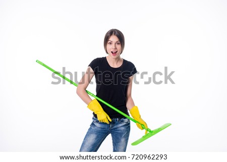 Cleaning girl happy excited during cleaning. Funny girl with cleaning mop playing guitar isolated on white background