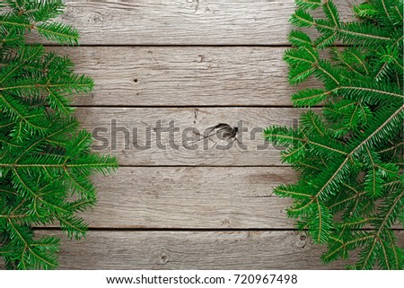 Christmas border background. Green fluffy pine tree twigs on aged wooden table. Winter holidays concept, top view, copy space