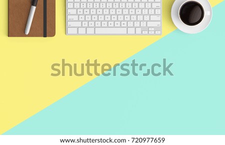 Modern workplace with notebook, coffee cup and keyboard copy space on color background. Top view. Flat lay style.